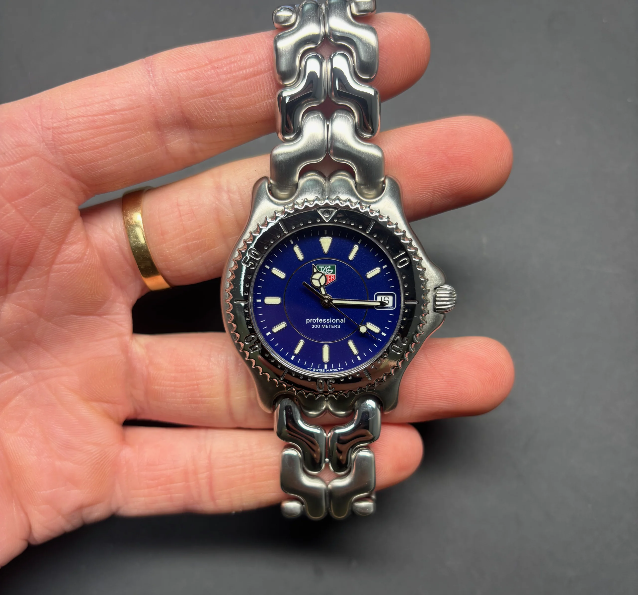 cropped hand craftsperson repairing wristwatch desk scaled
